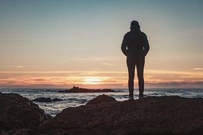 standing against sunrise